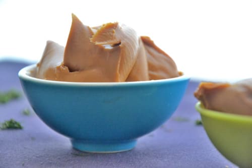 A blue bowl filled with heaps of smooth nut butter