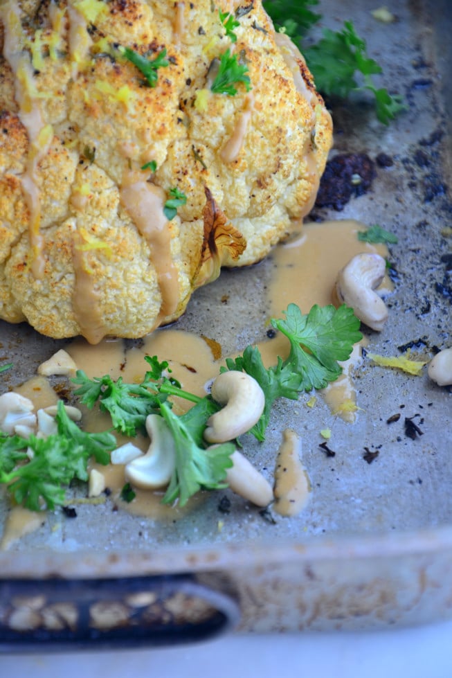 Whole Roasted Cauliflower topped with a tahini sauce, fresh herbs and lemon zest. 