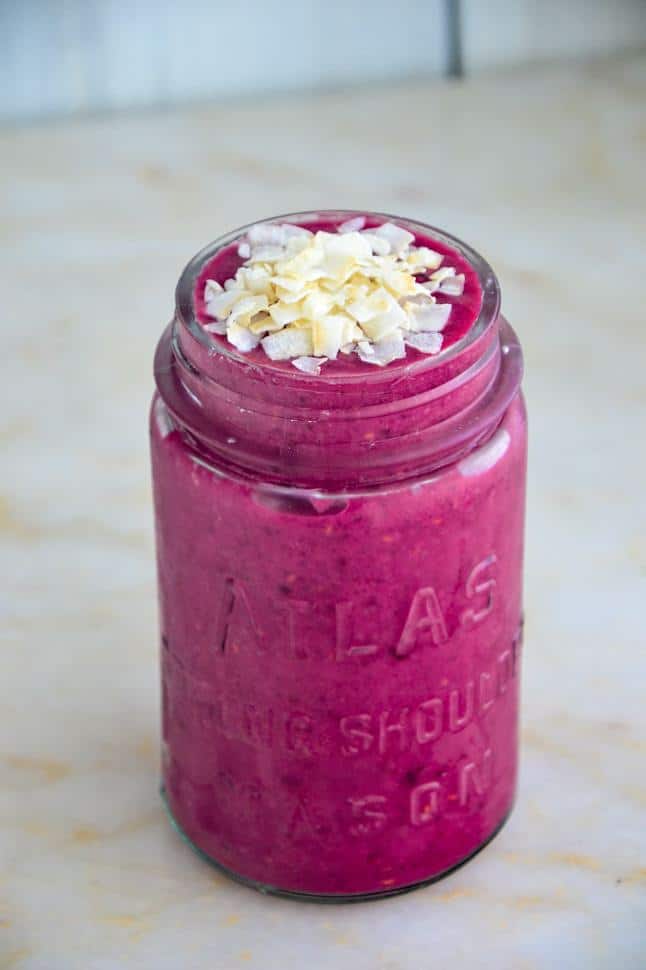 red velvet beet smoothie in a glass jar on a marble table.