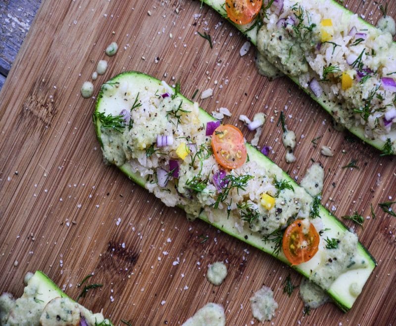 Simple Summer Zucchini Boats on a wooden cutting board.